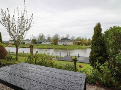 Holiday park Nice holiday home on the water in Friesland - Outdoor photo 2